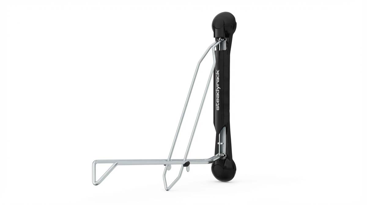 Steadyrack Classic vertical e-bike rack mounted on an apartment wall holding a heavy electric bicycle
